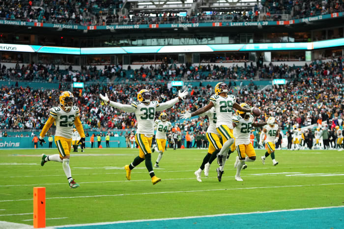 Packers defenders celebrate a game-clinching interception against the Dolphins