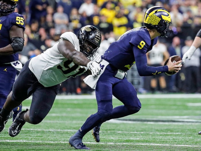 J.J. McCarthy runs from a Purdue defender