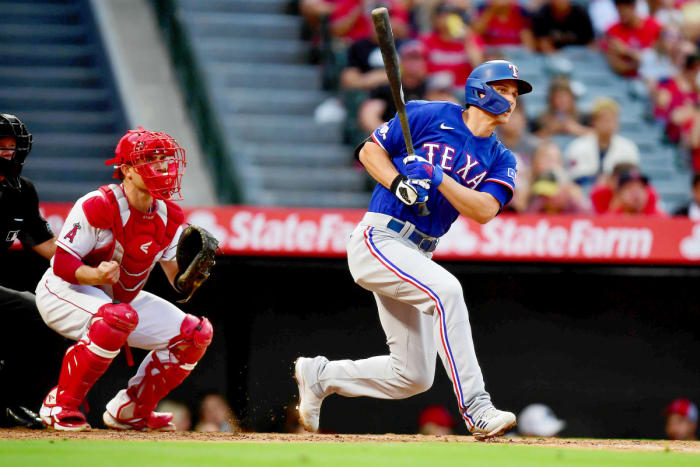 Rangers shortstop Corey Seager hits a single against the Angels during the third inning at Angel Stadium.