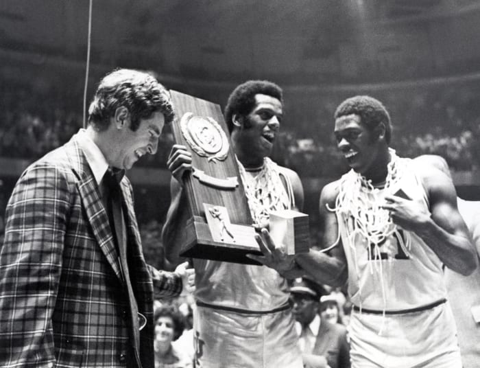 Indiana head coach Bobby Knight celebrates with forward Scott May (center) and guard Quinn Buckner (21) after winning the 1976 NCAA Basketball Championship.  The Hoosiers he defeated the Wolverines 86-68.