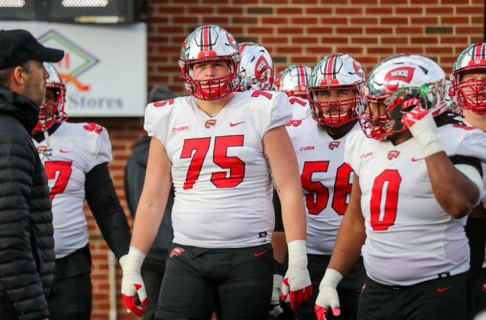 Nov 27, 2021; Huntington, West Virginia, USA; Western Kentucky Hilltoppers offensive lineman Gunner Britton (75) leads the team onto the field prior to their game against the Marshall Thundering Herd at Joan C. Edwards Stadium. Mandatory Credit: Ben Queen-USA TODAY Sports