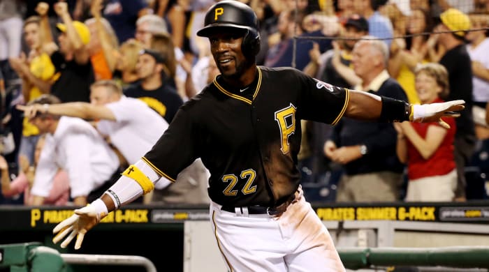 Pirates center fielder Andrew McCutchen (22) reacts after scoring the game-winning run against the Braves during the tenth inning.