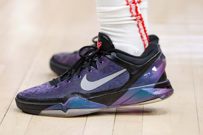 View of purple and black Nike Kobe shoes.