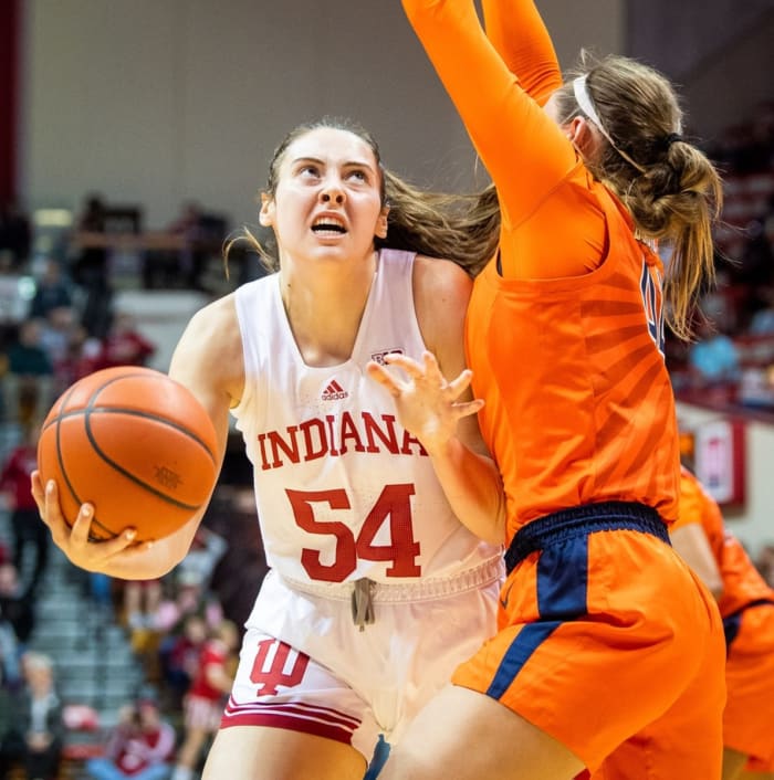 Mackenzie Holmes (54) of Indiana shoots around Kendall Bostic (44) of Illinois for a loose ball during the first half of the Indiana vs. Illinois women's basketball game at Simon Skjodt Assembly Hall on Sunday, December 4, 2022.