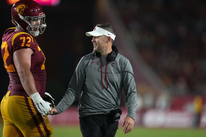 Los Angeles, California, USA; Southern California Trojans head coach Lincoln Riley and offensive lineman Andrew Vorhees (72) react in the second half against the Fresno State Bulldogs at United Airlines Field at Los Angeles Memorial Coliseum.