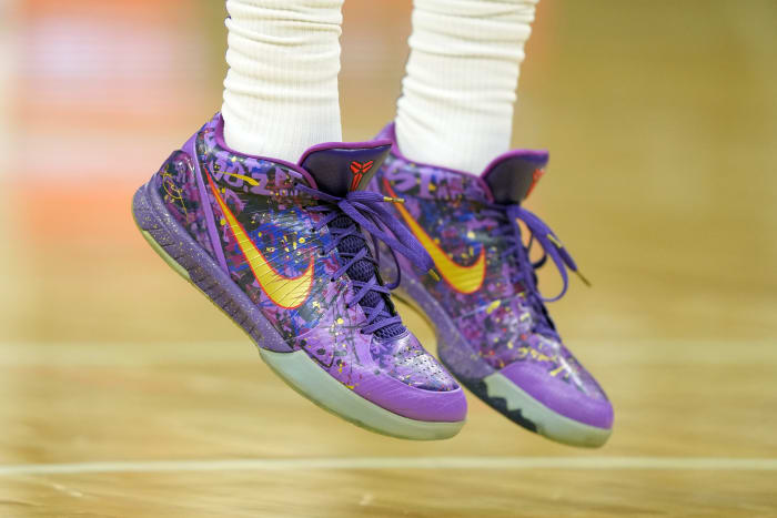 View of purple and yellow Nike Kobe shoes.