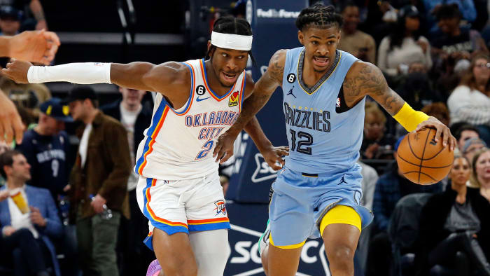 Memphis Grizzlies guard Ja Morant pushes the ball up the court as Oklahoma City Thunder guard Shai Gilgeous-Alexander.