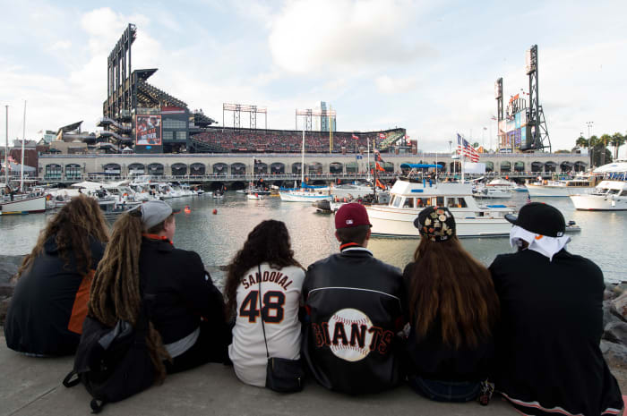 Fans sit across McCovey Cove from Oracle Park