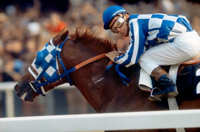 Jockey Ron Turcotte, who seemingly couldn’t believe it either, looks at the infield teletimer in the home stretch of the 1973 Belmont Stakes—a race Secretariat won by 31 lengths.