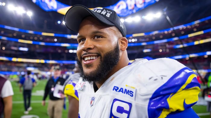 Aaron Donald smiling on the field after winning Super Bowl LVI