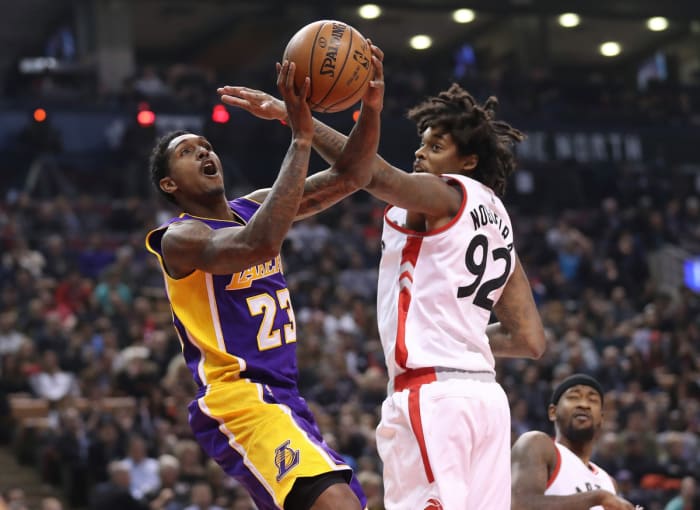 Los Angeles Lakers point guard Lou Williams (23) goes up to the basket against Toronto Raptors center Lucas Nogueira (92) at Air Canada Center.