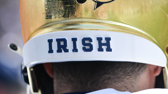The back of a football helmet from Notre Dame with the word written on it "Irish" written.