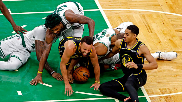 Golden State Warriors guard Stephen Curry (30) and guard Jordan Poole (3) go for the ball against Boston Celtics center Al Horford (42), guard Marcus Smart (36) and center Robert Williams III.