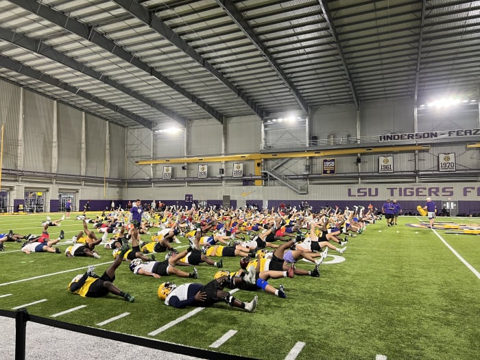 Offensive linemen stretch before the LSU OL/DL camp Friday, June 10. 