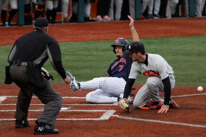 Jun 12, 2022;  Corvallis, OR, USA;  Auburn baseball infielder Cole Foster (7) scores a run past Oregon State Beavers pitcher Cooper Hjerpe (26) in the 4th inning during Game 2 of a NCAA Super Regional game at Coleman Field.