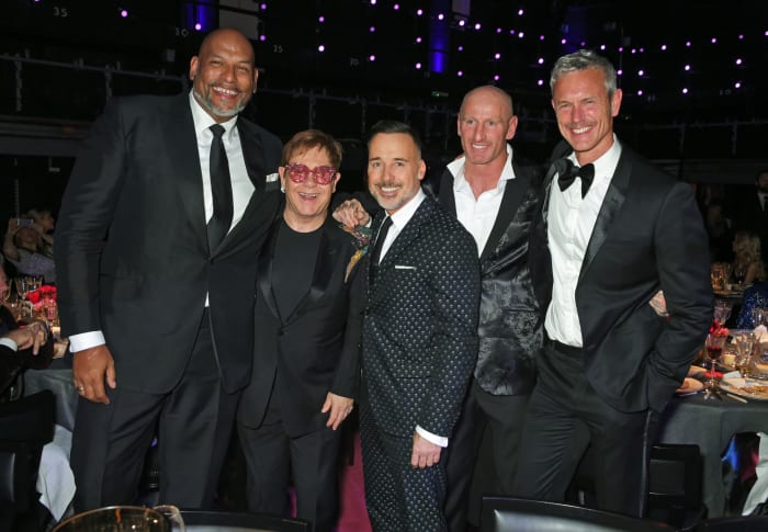 Amaechi, in 2017, joined Elton John (glasses) and gay rugby player Gareth Thomas (second from right) at an AIDS Foundation benefit in London.