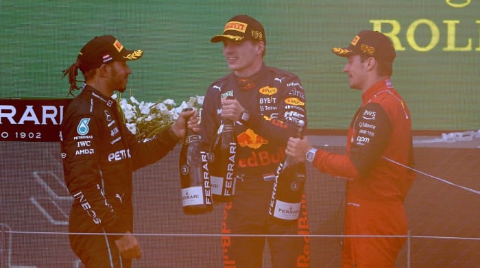 Lewis Hamilton, Max Verstappen and Charles Leclerc on podium after Austrian Grand Prix.