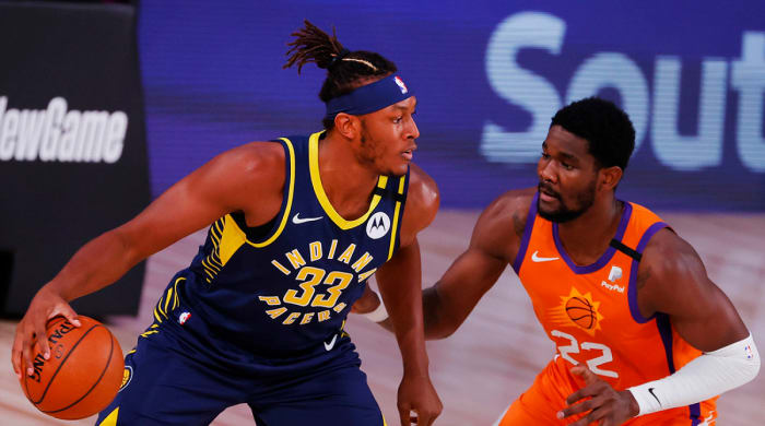 Pacers center Myles Turner (33) handles the ball as Suns center Deandre Ayton (22) defends him.