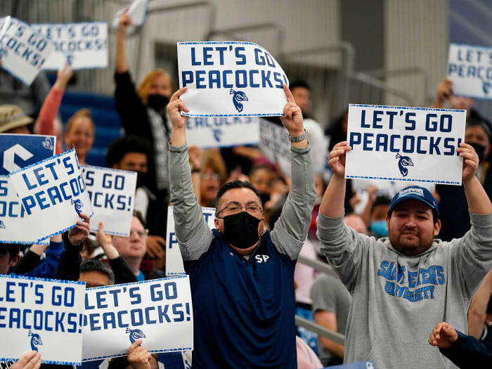 Saint Peter’s fans hold up “Let’s Go Peacocks” signs