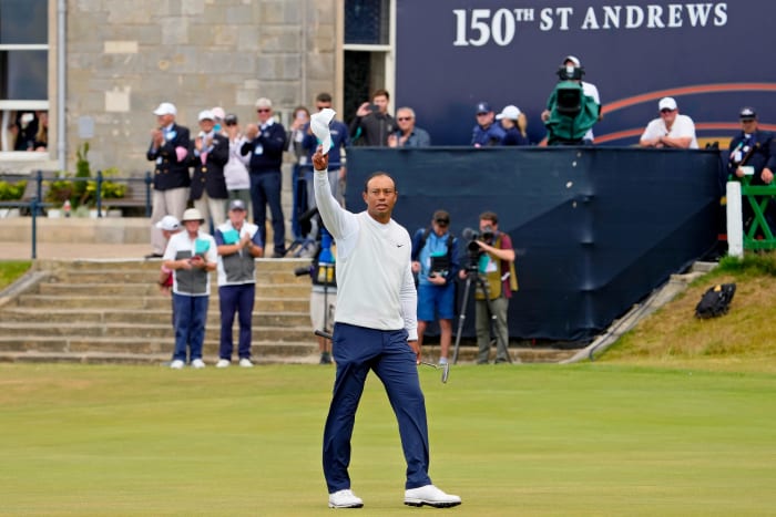 Tiger Woods tips his hat to the crowd after teeing off on the 18th hole during the second round of the 150th Open Championship golf tournament at St. Andrews Old Course.