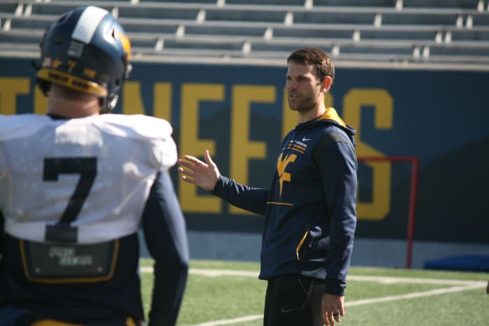 West Virginia offensive coordinator Graham Harrell giving instructions to his quarterbacks during spring practice.