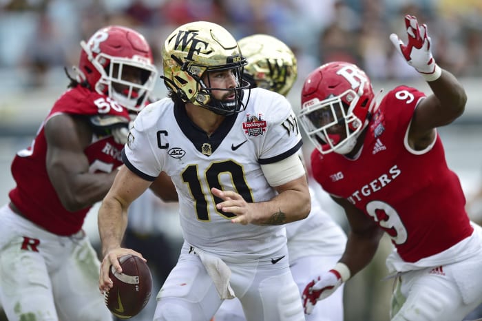 Wake Forest quarterback Sam Hartman (10) is pressured into the Rutgers pocket during the second quarter at the Gator Bowl during an NCAA College football game, Friday, Dec. 31, 2021, in Jacksonville, in Florida.