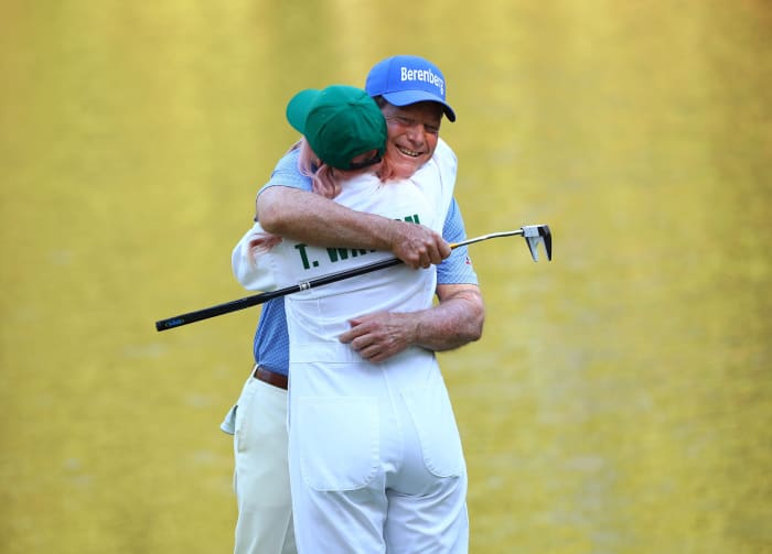 Tom Watson hugs a guest during the Par 3 Contest at Augusta National Golf Club.