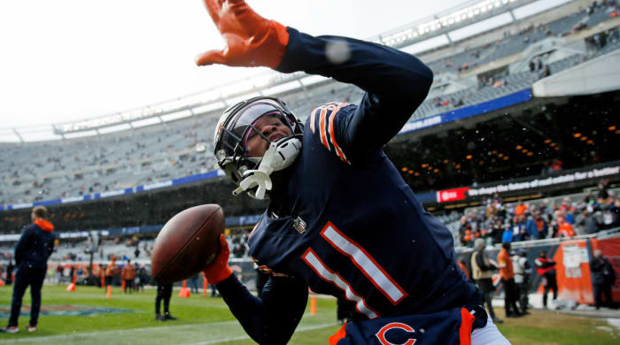 Chicago Bears wide Darnell Mooney (11) throws the ball into the stands as he plays with fans during the pre-game warm-up against the New York Giants at Soldier Field.