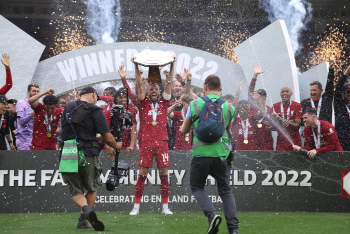 Liverpool captain Jordan Henderson pictured lifting the Community Shield trophy in 2022