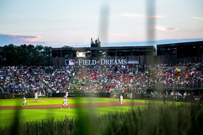 Le soleil se couche lors d'un match de la Ligue majeure de baseball entre les Reds de Cincinnati et les Cubs de Chicago, le jeudi 11 août 2022, au Field of Dreams à Dyersville, Iowa.