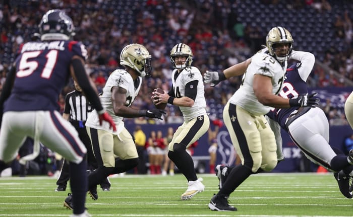 New Orleans Saints quarterback Andy Dalton, 14, is looking for an open receiver against the Houston Texans. Required Credit: Troy Taormina-USA TODAY Sports