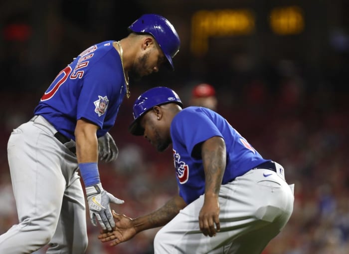 08/13/2022;  Cincinnati, Ohio, USA;  Chicago Cubs catcher Willson Contreras (40) reacts with third base coach Willie Harris (right) after hitting a solo home run against the Cincinnati Reds in the ninth inning at Great American Ball Park.  Mandatory Credit: David Kohl-USA TODAY Sports