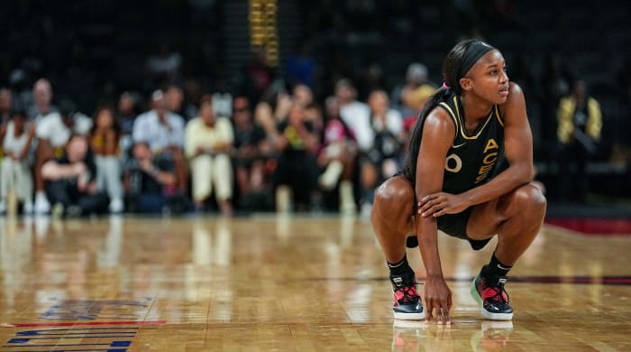 Las Vegas ace Jackie Young rests on the court during a game against the Seattle Storm.