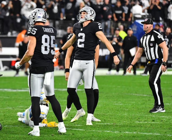 January 9, 2022; Paradise, Nevada, USA. Las Vegas Raiders kicker Daniel Carlson, 2, won the game against the Los Angeles Chargers in overtime to give the Raiders his 35-32 victory and a playoff bid at Allegiant's stadium. Field watching the ball after kicking his goal. Mandatory Credit: Stephen R. Sylvanie-USA TODAY Sports
