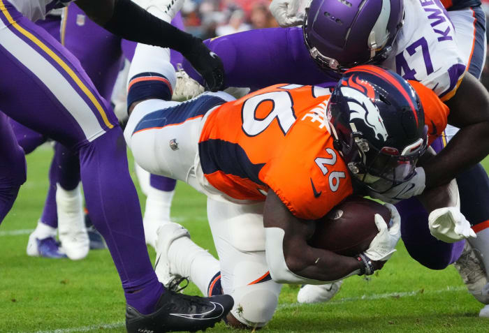 Minnesota Vikings linebacker William Kwenkeu (47) tackles Denver Broncos running back Mike Boone (26) in the first quarter at Empower Field in Mile High.