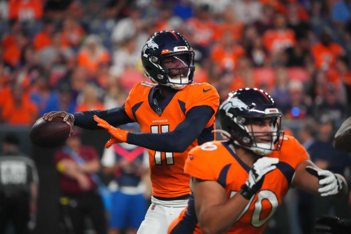 Denver Broncos quarterback Josh Johnson (11) drops back to pass the ball against the Minnesota Vikings in the second half at Empower Field at Mile High.