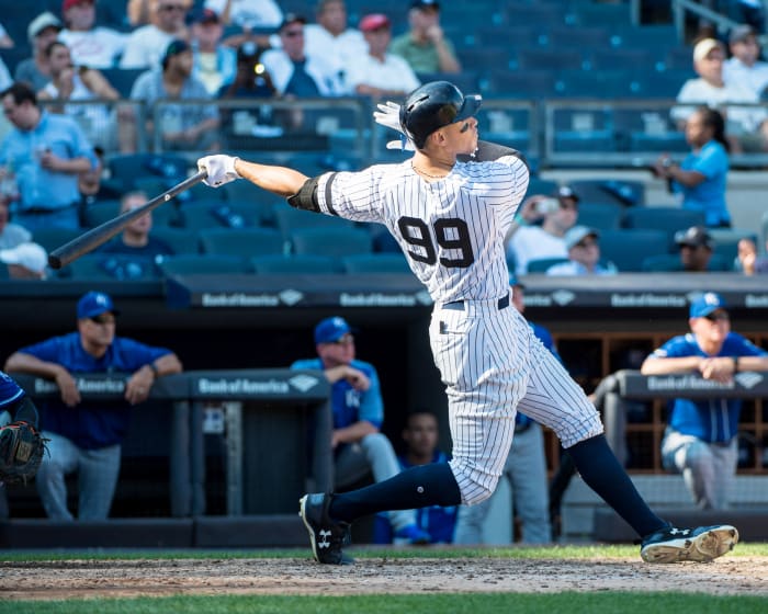 Sep 25, 2017; Bronx, NY, USA; New York Yankees right fielder Aaron Judge (99) hits his recored breaking 50th home run against the Kansas City Royals during the seventh inning of the game at Yankee Stadium.