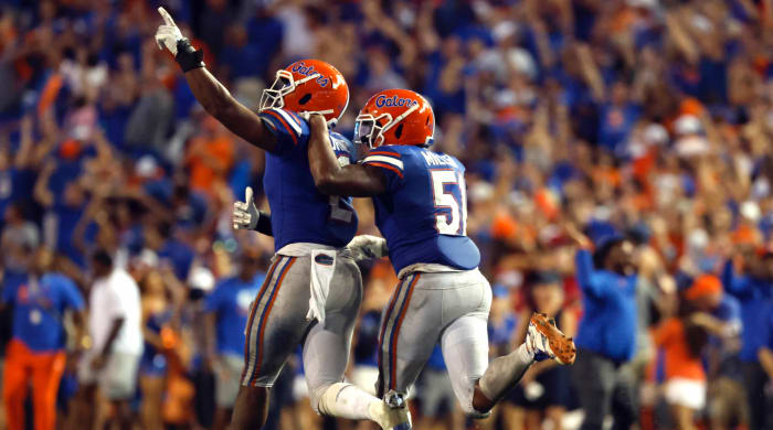 Florida Gators linebacker Amari Burnie (2) collides with linebacker Ventrell Miller (51) after intercepting Utah State's ball in the second half at Steve Springer-Florida Field. years) to celebrate together.