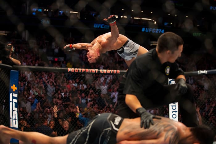 Michael Chandler celebrates with a backflip after knocking out Tony Ferguson at UFC 274 at Footprint Center.