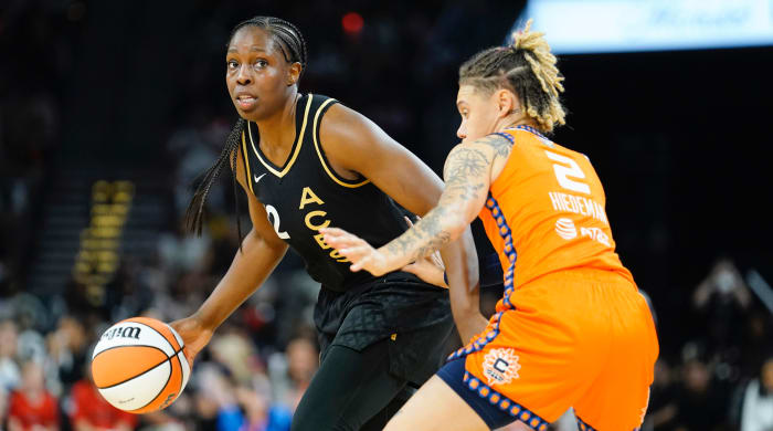 Las Vegas Aces guard Chelsea Gray (12) controls the ball against Connecticut Sun guard Natisha Hiedeman (2) during the second quarter in game one of the 2022 WNBA Finals at Michelob Ultra Arena.
