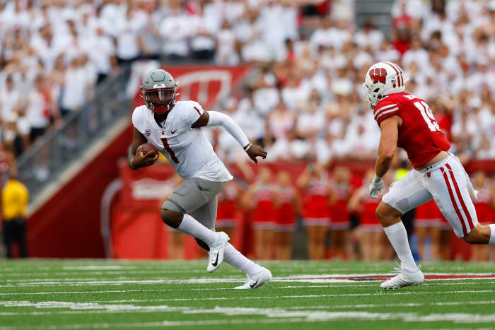 Washington State Cougars quarterback Cameron Ward (1) scrambles with the football under pressure from Wisconsin Badgers linebacker Nick Herbig (19) during the fourth quarter at Camp Randall Stadium.
