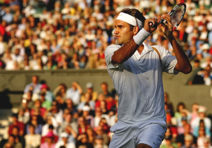 Roger Federer replays a shot against Marat Safin in the third round of Wimbledon 2007.