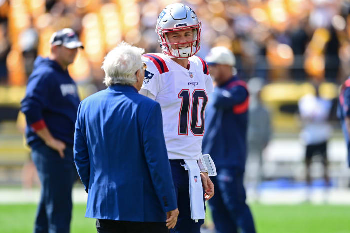 New England Patriots owner Robert Kraft talks with New England Patriots quarterback Mac Jones (10) before the game against the Pittsburgh Steelers at Acrisure Stadium.