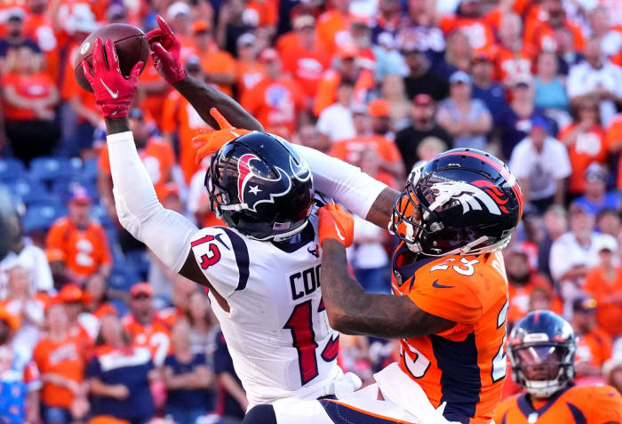 Houston Texans wide receiver Brandin Cooks (13) reaches for the ball in the second half at Empower Field at Mile High, past Denver Broncos cornerback Ronald Darby (23).
