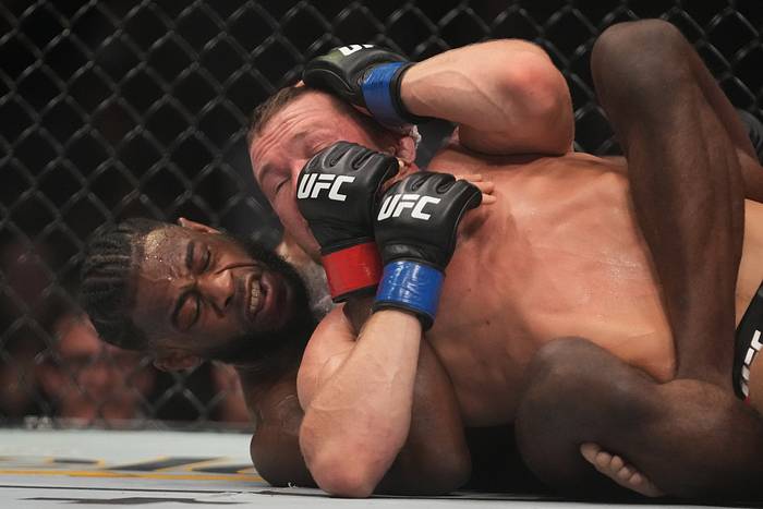 Aljamain Sterling (Red Gloves) fights Peter Yan (Blue Gloves) during UFC 273 at VyStar Veterans Memorial Arena.
