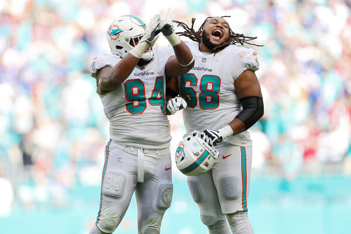 Christian Wilkins and Robert Hunt celebrate the Dolphins' victory over the Bills.