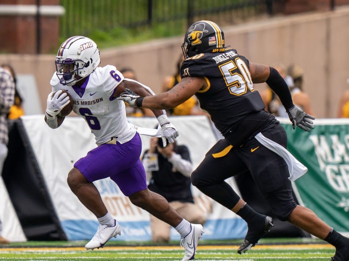 James Madison's Kaelon Black dodges a tackle from App State