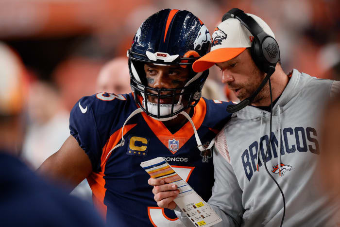Denver Broncos quarterback Russell Wilson (3) speaks with quarterbacks coach Clint Kubik in the second quarter against the San Francisco 49ers at Empower Field at Mile High.