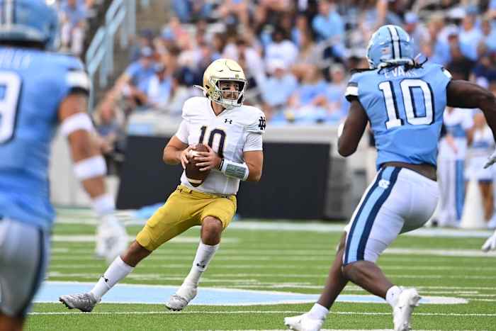 Sep 24, 2022; Chapel Hill, North Carolina, USA; Notre Dame Fighting Irish quarterback Drew Pyne (10) looks to pass as North Carolina Tar Heels defensive back Cam'Ron Kelly (9) and defensive lineman Desmond Evans (10) pressure in the second quarter at Kenan Memorial Stadium. Mandatory Credit: Bob Donnan-USA TODAY Sports