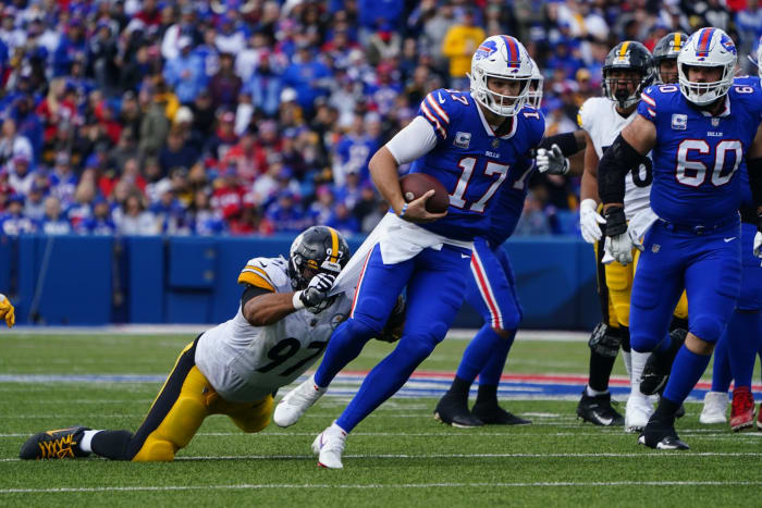 Bills quarterback Josh Allen escapes Steelers defender Cameron Heyward.